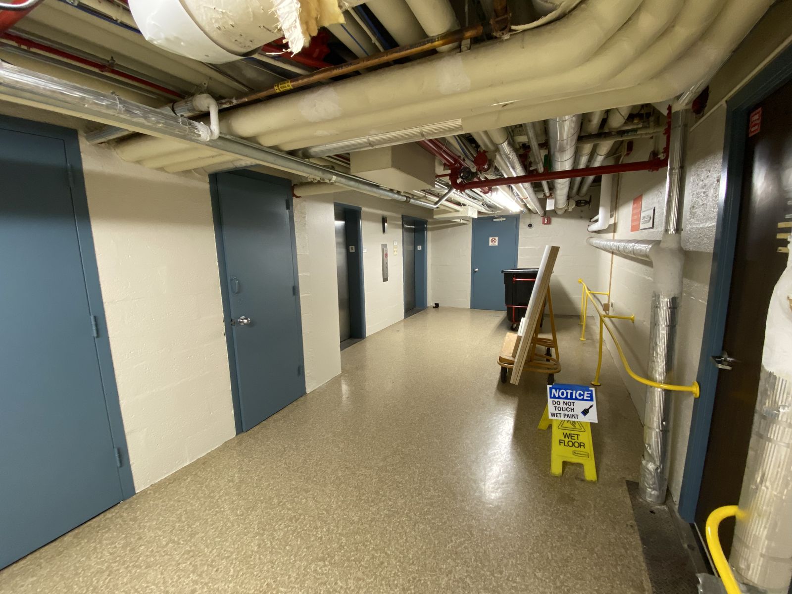Commercial corridor with terrazzo flooring and freshly painted walls
