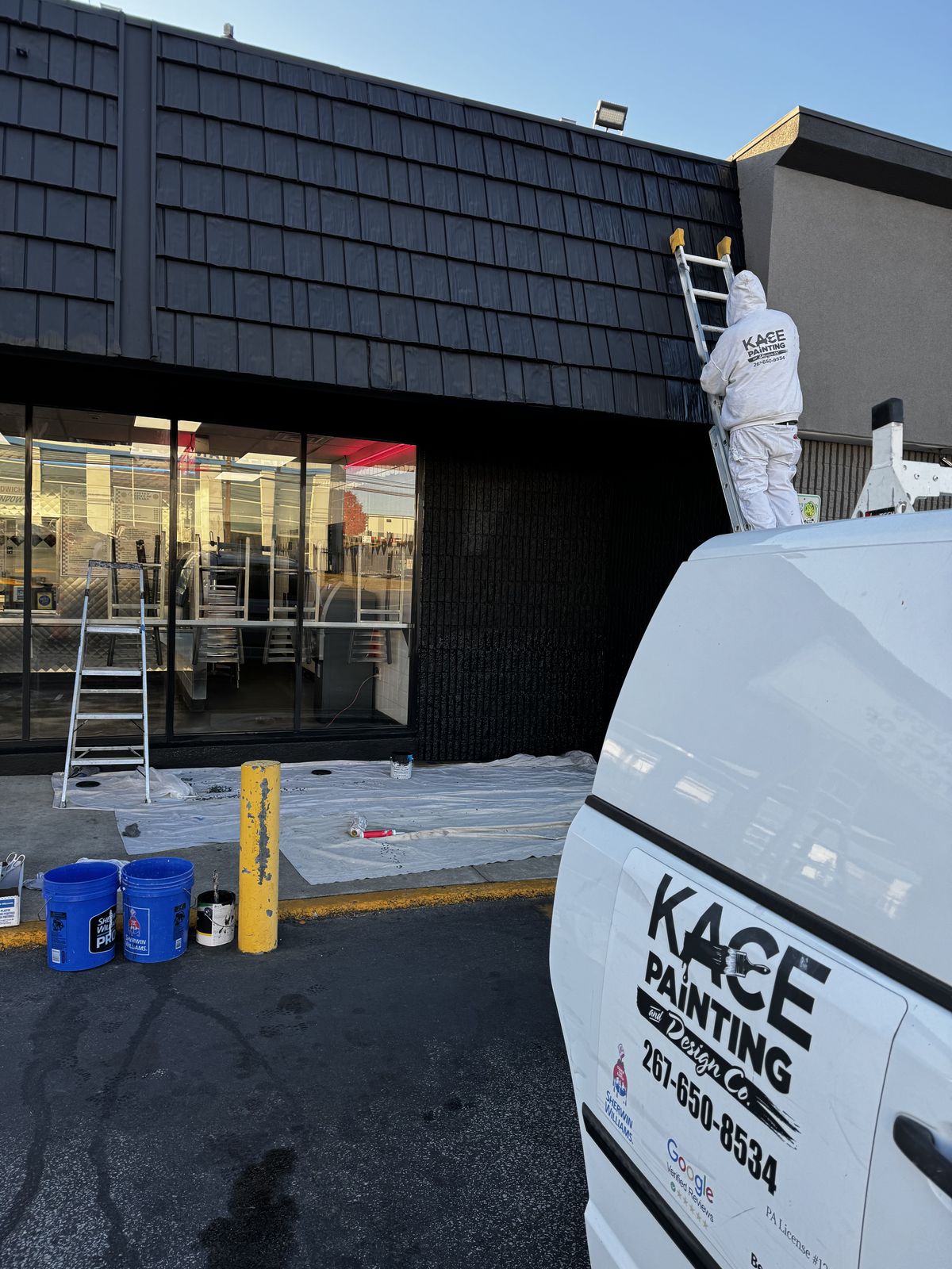 Painter working on a commercial storefront entrance