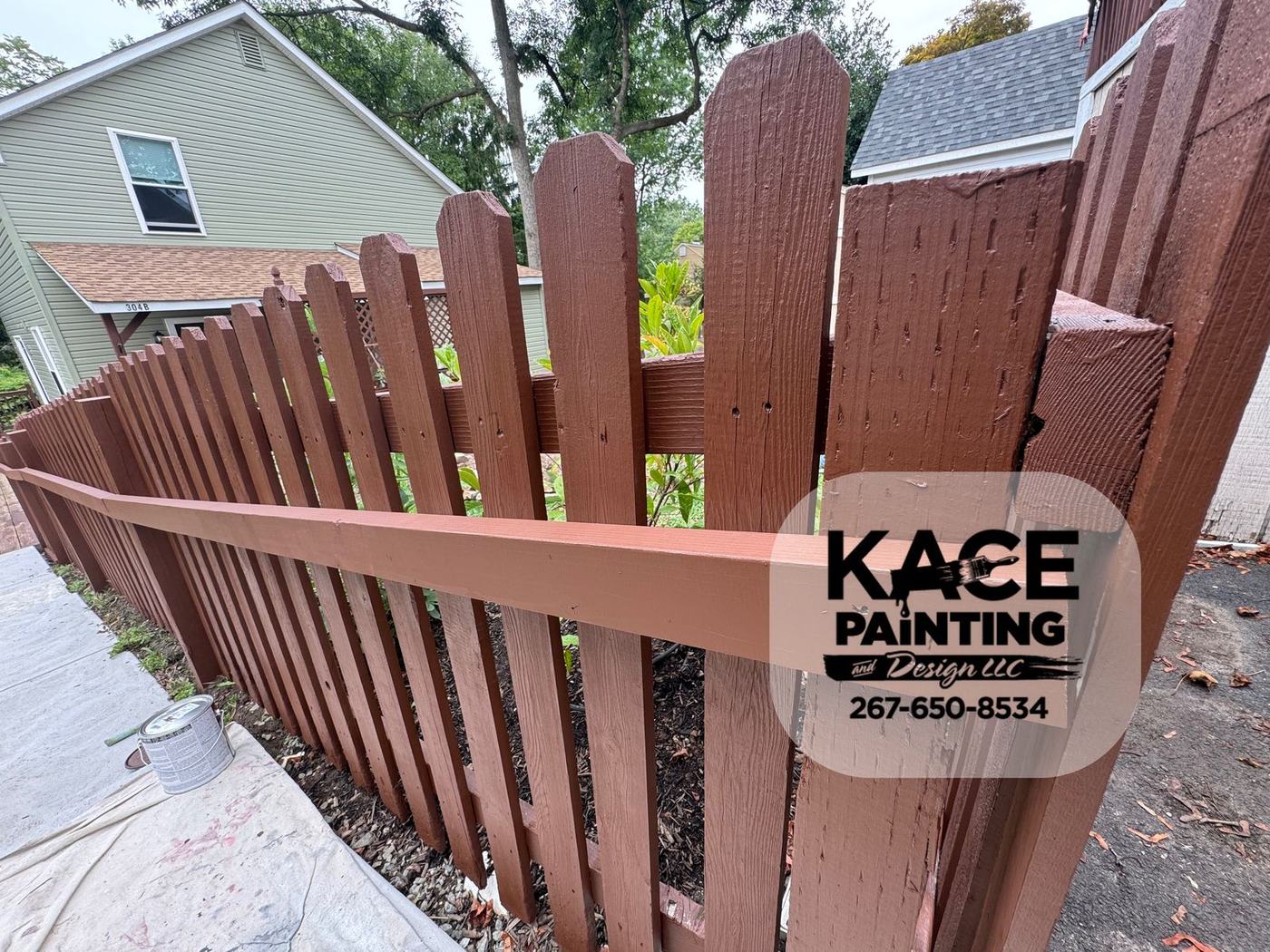 Wood privacy fence stained deep red