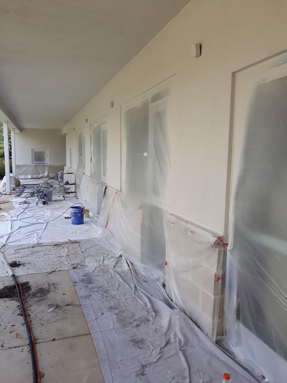 Hallway masked with plastic sheeting and floor protection before painting
