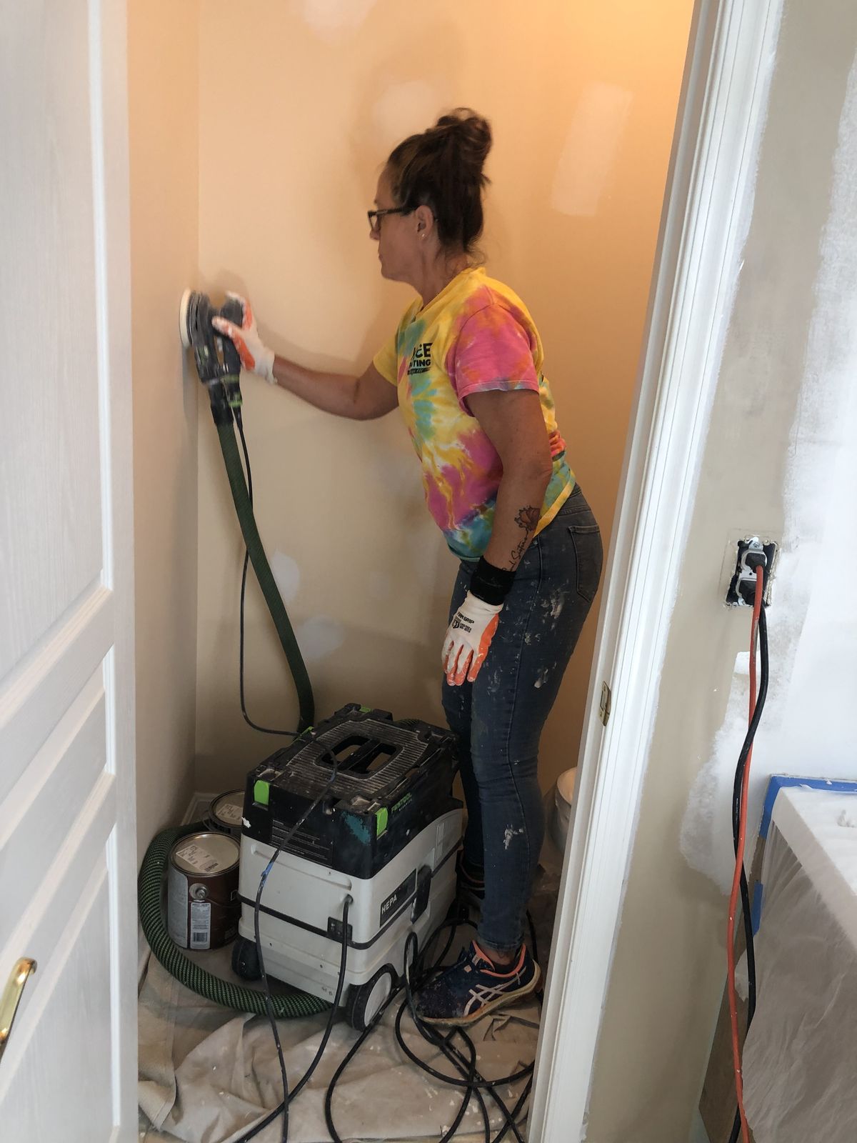 Kathy Cochran sanding with HEPA filtration equipment on a KACE Painting job