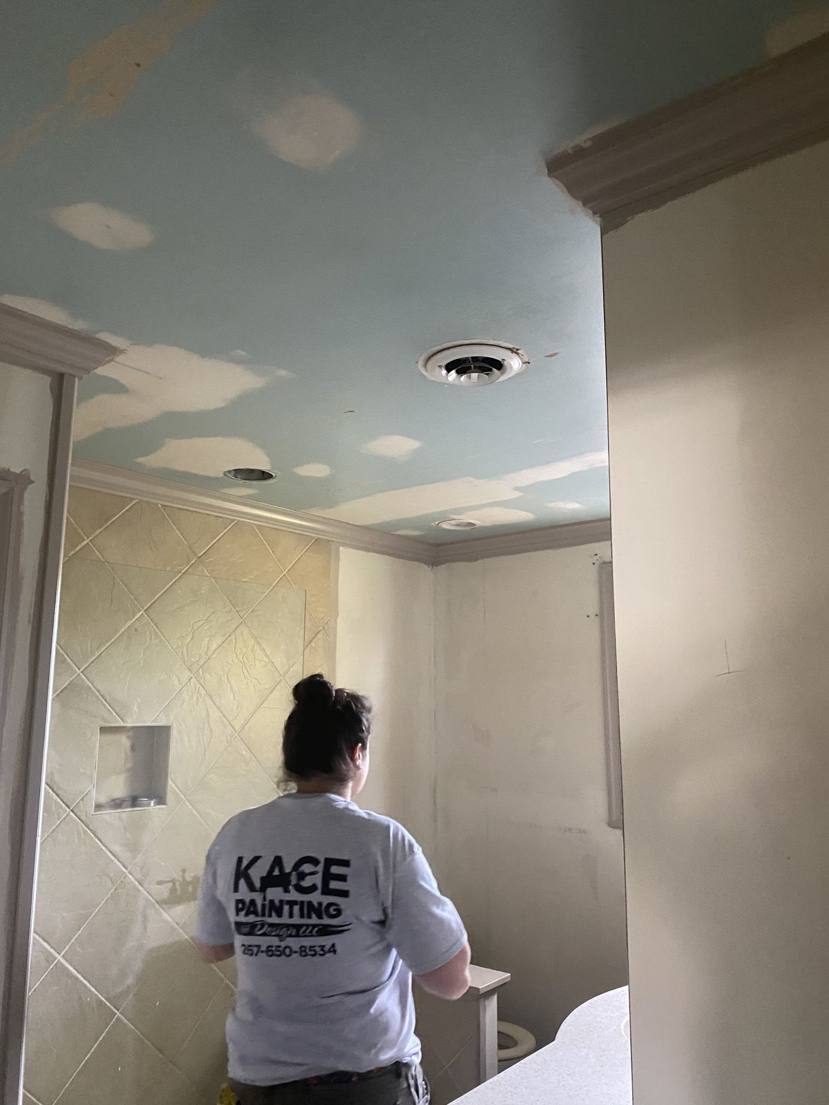 KACE painter finishing a ceiling in a fully prepped room