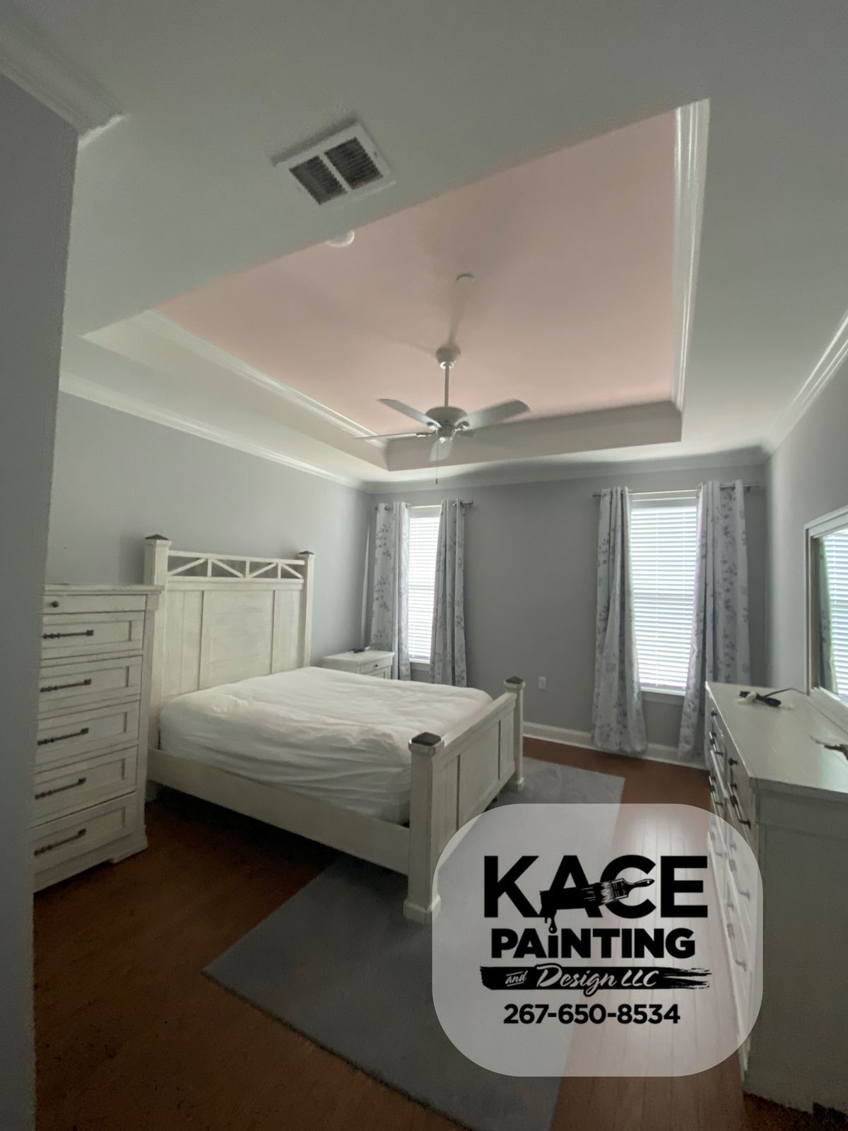 Bedroom with a tray ceiling and soft neutral walls
