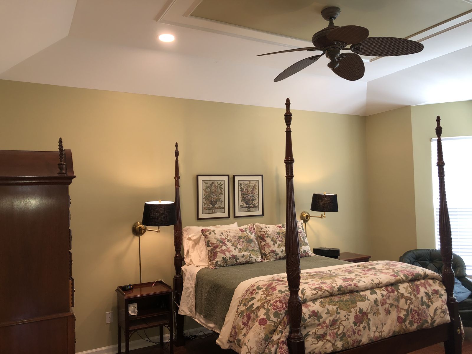 Bedroom with sage green walls and a four poster bed