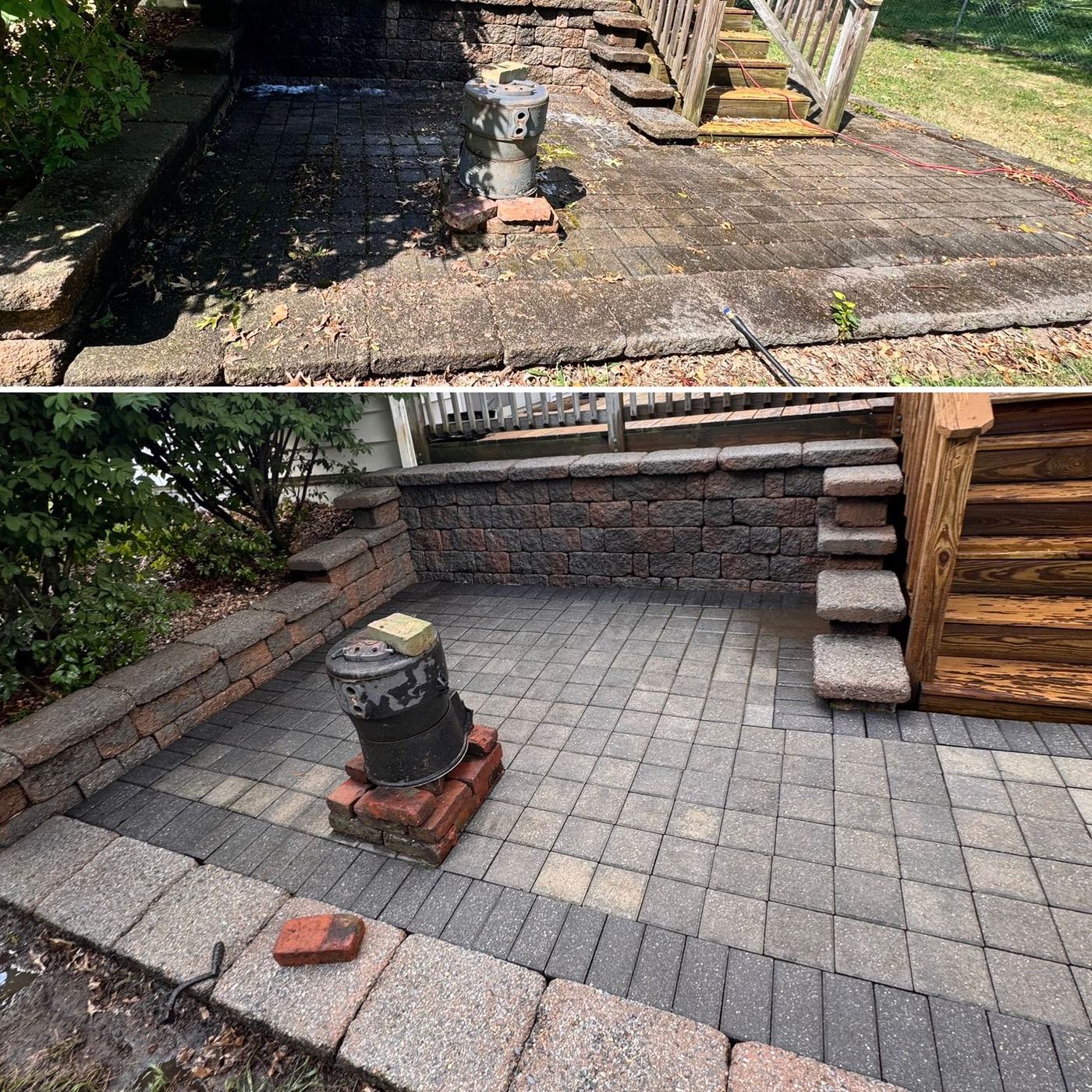 Paver patio and retaining wall being pressure washed