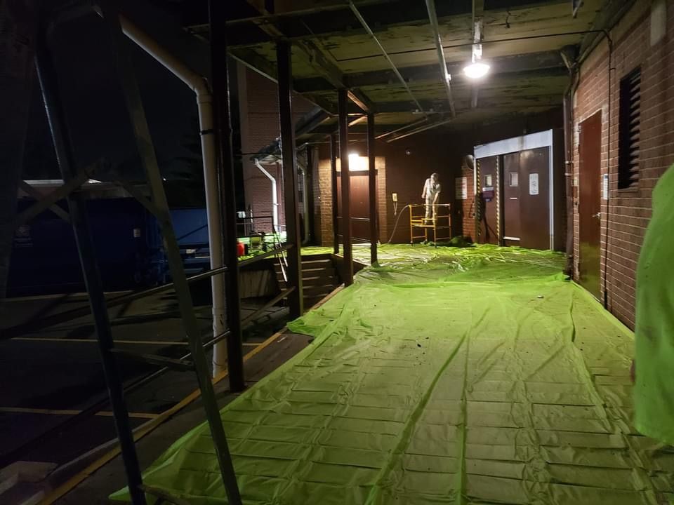 Large interior space with scaffolding and full floor protection