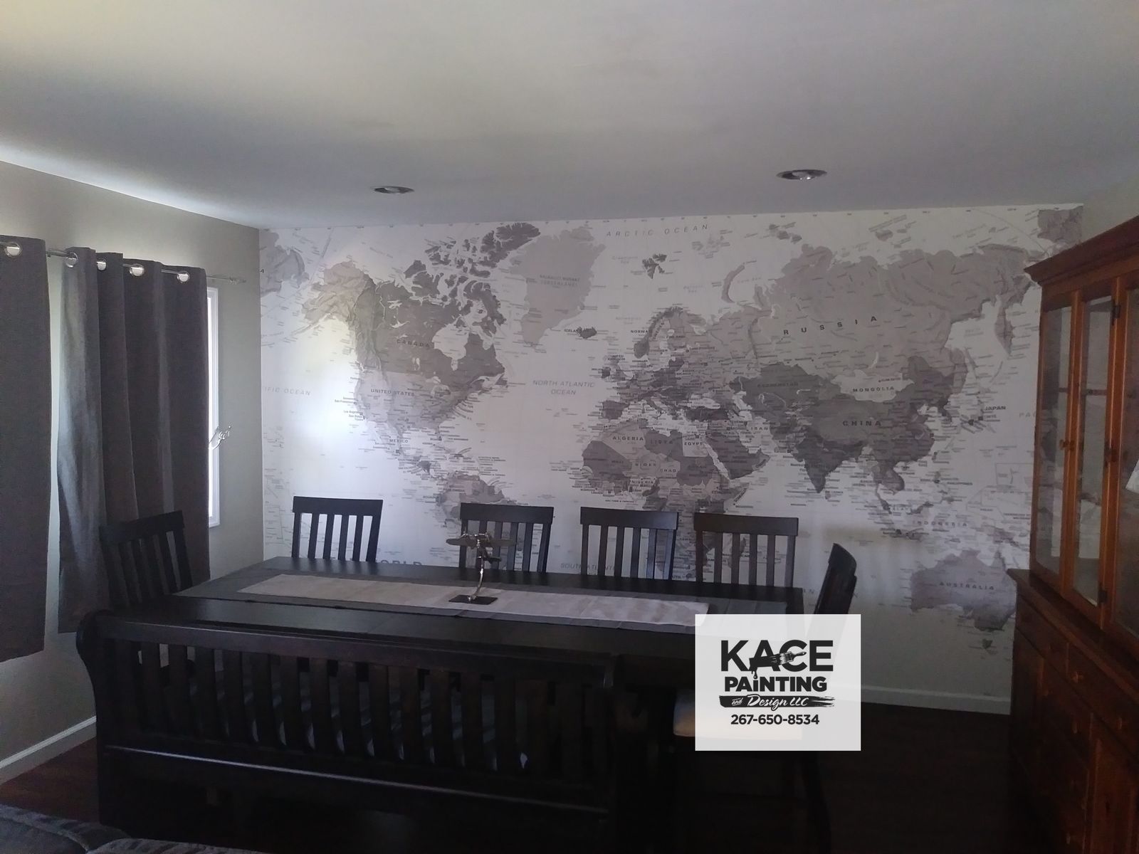 Bedroom with a map patterned wallpaper feature wall