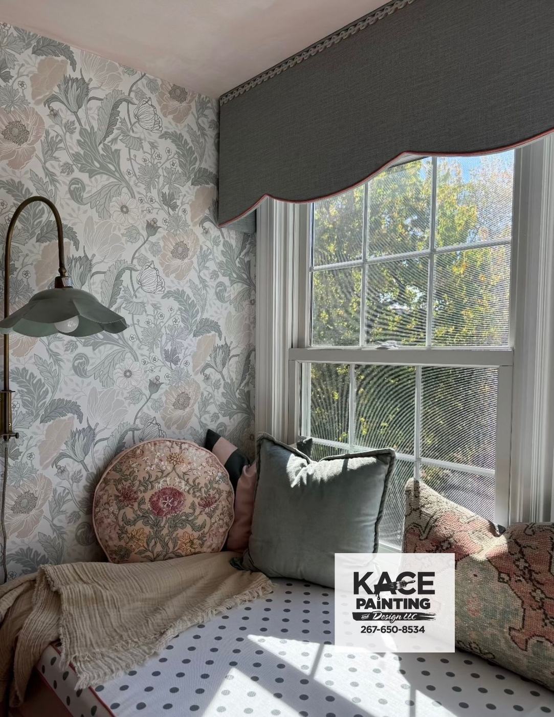 Bedroom with patterned wallpaper and a window valance