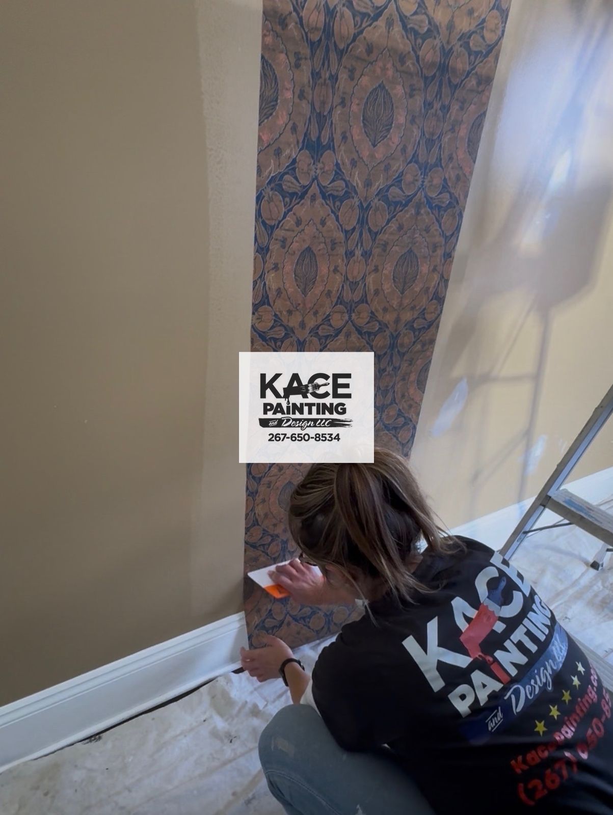 Installer smoothing wallpaper onto a bedroom wall
